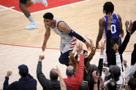 Washington Wizards forward Rui Hachimura (8) reacts after he made a three-point basket during the second half of Game 4 in a first-round NBA basketball playoff series against the Philadelphia 76ers, Monday, May 31, 2021, in Washington. 76ers guard Tyrese Maxey (0) looks on. (AP Photo/Nick Wass)