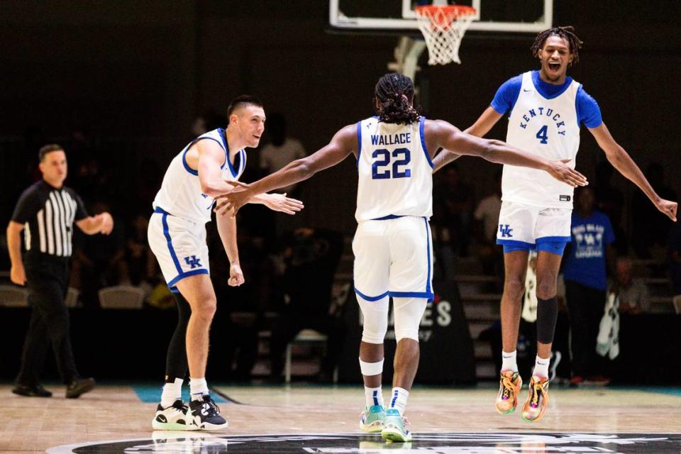 Cason Wallace celebrates with Kentucky teammates CJ Fredrick, left, and Daimion Collins during UK’s 108-56 victory over the Dominican Republic National Select Team.