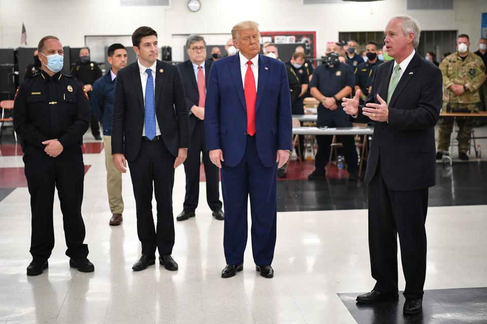 In September 2020, then-President Trump listens to U.S. Sen. Ron Johnson during a tour of an emergency operations center at Mary D. Bradford High School in Kenosha.