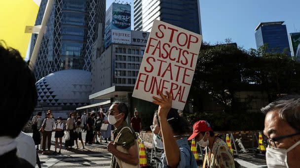 PHOTO: People hold signs and chant slogans during the march to protest against Shinzo Abe's State Funeral, on Sept. 25, 2022, in Tokyo, Japan (Takashi Aoyama/Getty Images)