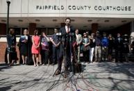 Attorney Josh Koskoff speaks to media members as family members of victims of the Sandy Hook Elementary School shooting stand behind him before a hearing at the Fairfield County Courthouse in Bridgeport, Connecticut, U.S., June 20, 2016, where the maker of the gun used in the 2012 massacre of 26 young children and educators at the Connecticut elementary school will ask a judge to toss a lawsuit saying the weapon never should have been sold to a civilian. REUTERS/Mike Segar