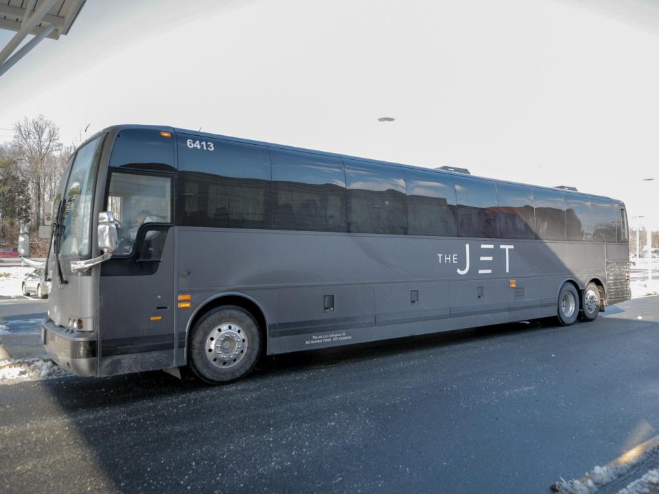 A matte black bus that reads "The Jet" on the side.