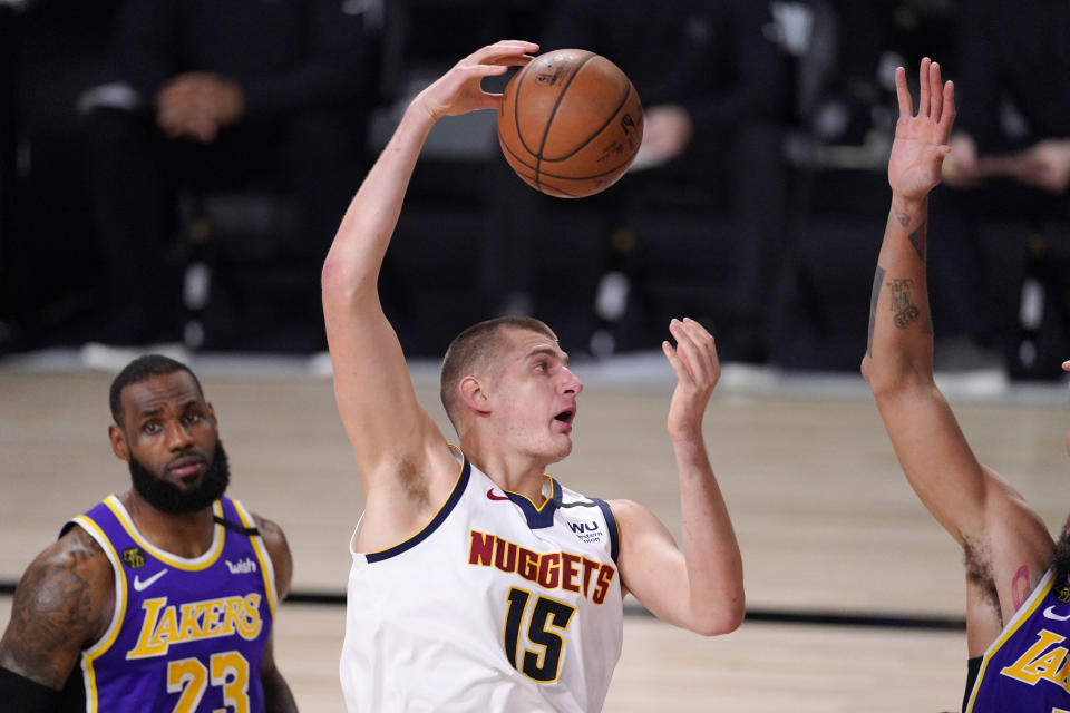 Denver Nuggets' Nikola Jokic (15) plays against the Los Angeles Lakers during the first half of an NBA conference final playoff basketball game Saturday, Sept. 26, 2020, in Lake Buena Vista, Fla. (AP Photo/Mark J. Terrill)