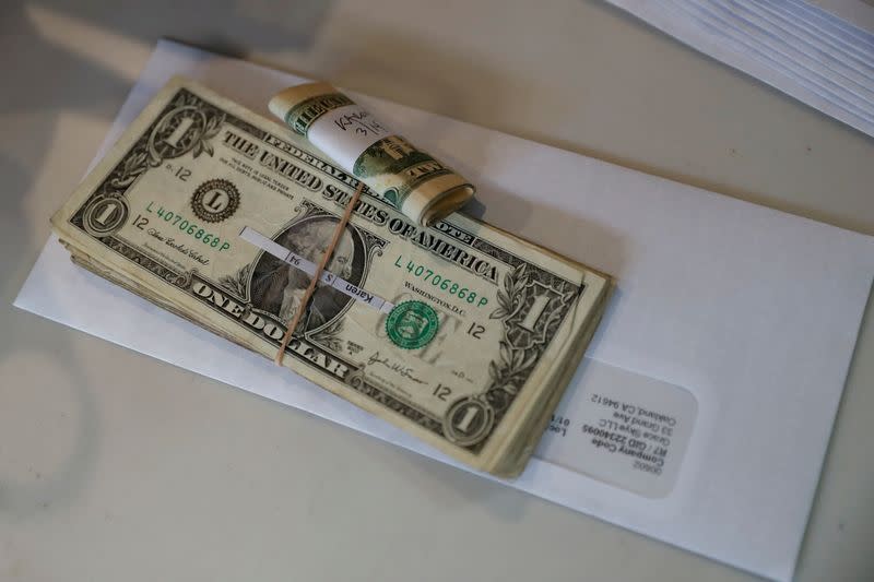 FILE PHOTO: Tips, money collected from a customer donation fund and a last paycheck for employees laid off from Farley’s East cafe, that closed due to the financial crisis caused by the coronavirus disease (COVID-19), sits on a counter at the cafe in Oak