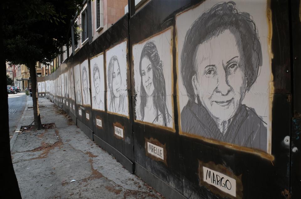 Sketches of victims of the port explosion hang on a wall in downtown Beirut (EPA)