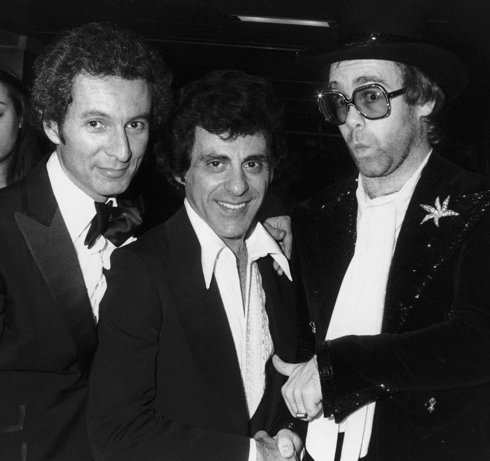 Ron Delsener, Frankie Valli and Elton John at a party for the premiere of Ken Russell's film 'Tommy' in the Sixth Avenue Subway on March 18, 1975, in New York.