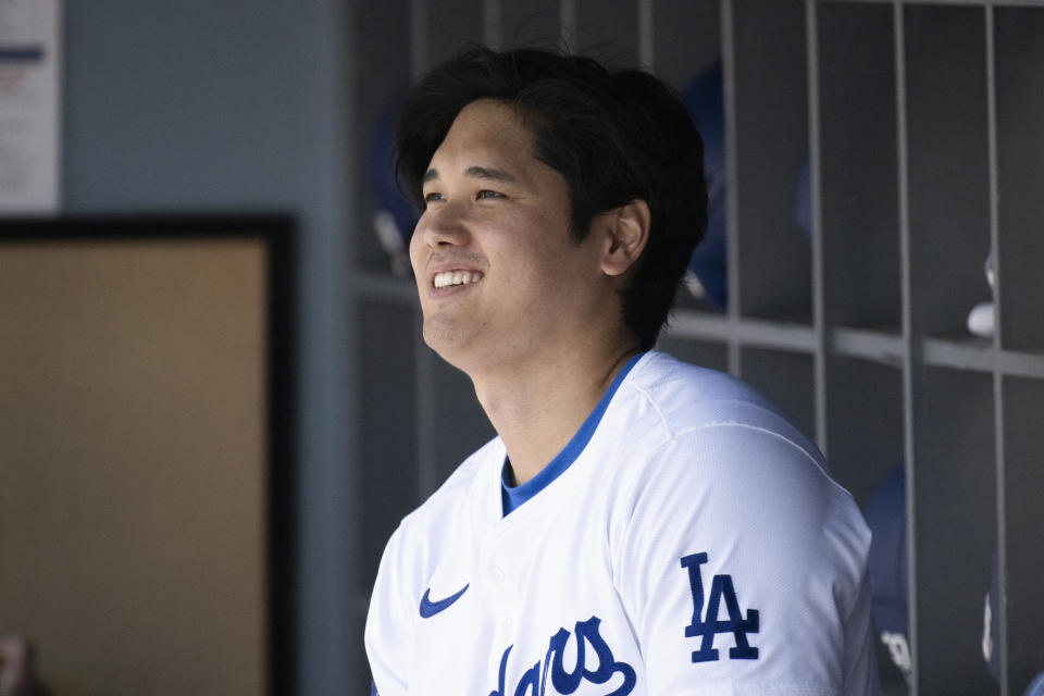 Los Angeles Dodgers' Shohei Ohtani smiles before a baseball game against the New York Mets in Los Angeles, Sunday, April 21, 2024. (AP Photo/Kyusung Gong)
