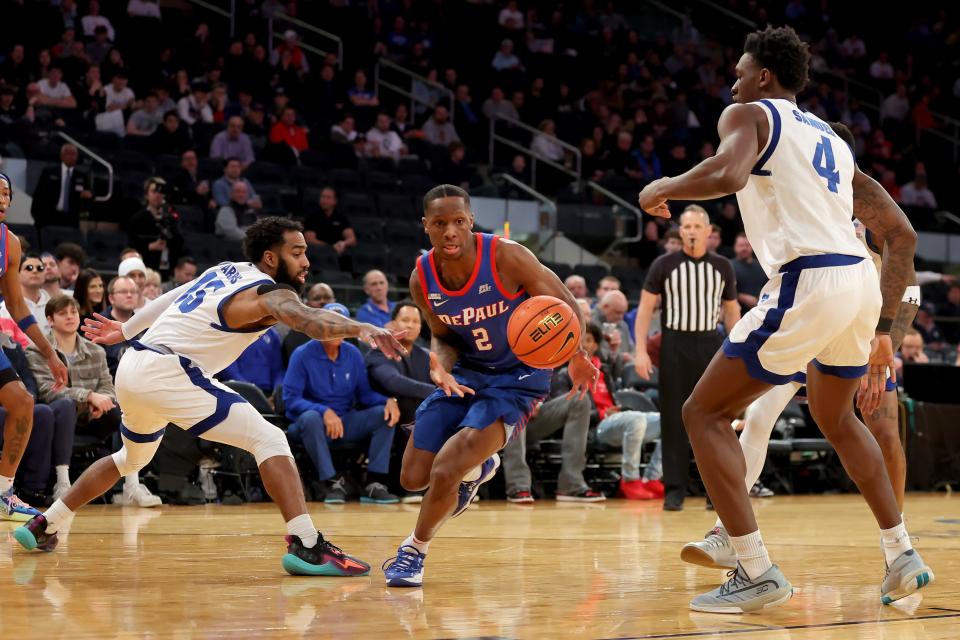 DePaul Blue Demons guard Umoja Gibson (2) chases a loose ball against Seton Hall Pirates guard Jamir Harris (15) and forward Tyrese Samuel (4) during the first half at Madison Square Garden.