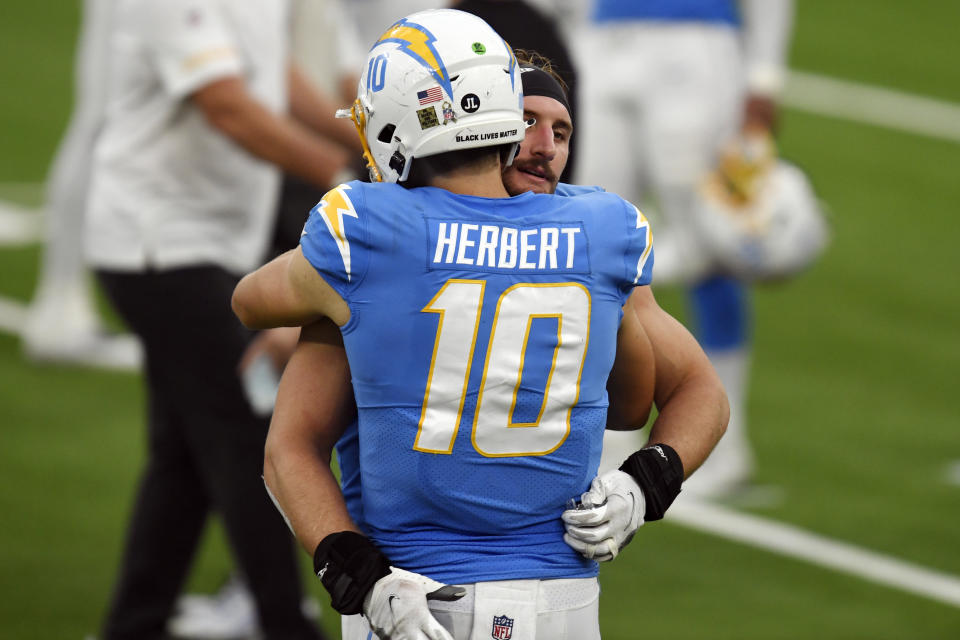 Los Angeles Chargers quarterback Justin Herbert (10) hugs teammate Joey Bosa after a win over the New York Jets during an NFL football game Sunday, Nov. 22, 2020, in Inglewood, Calif. (AP Photo/Kyusung Gong)
