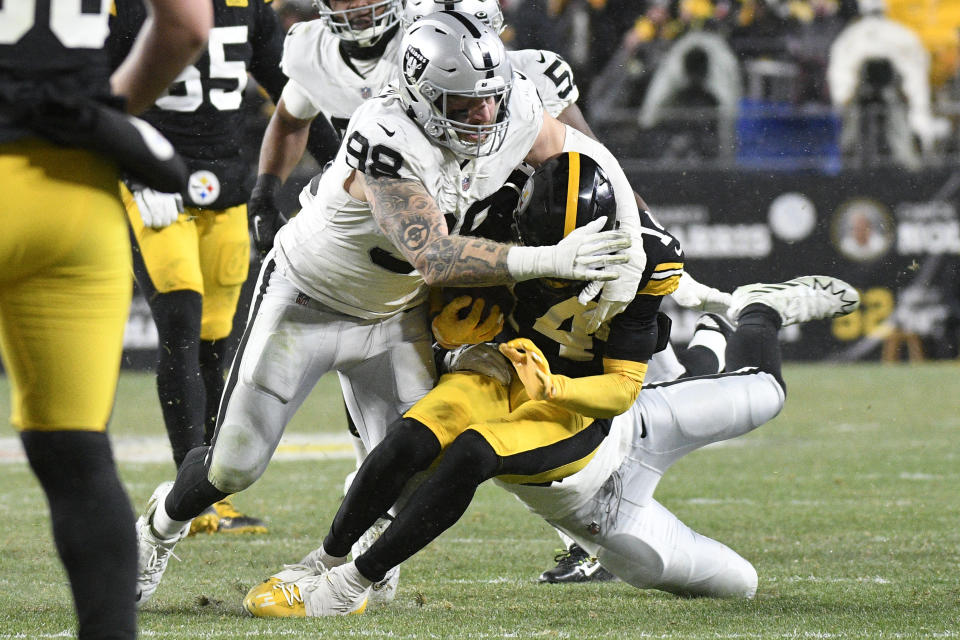 Pittsburgh Steelers wide receiver George Pickens (14) is tackled by Las Vegas Raiders defensive end Maxx Crosby (98) during the second half of an NFL football game in Pittsburgh, Saturday, Dec. 24, 2022. (AP Photo/Don Wright)