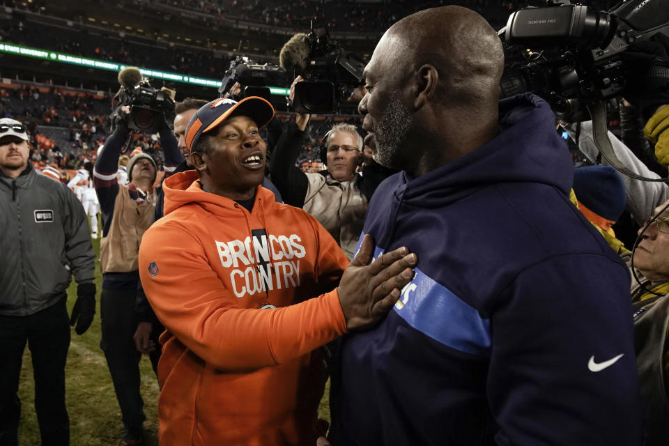 Denver Broncos head coach Vance Joseph, front left, greets Los Angeles Chargers head coach Anthony Lynn after an NFL football game, Sunday, Dec. 30, 2018, in Denver. (AP Photo/Jack Dempsey)
