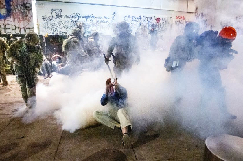 Federal officers use chemical irritants and crowd control munitions to disperse Black Lives Matter protesters outside the Mark O. Hatfield United States Courthouse on Wednesday, July 22, 2020, in Portland, Ore. (AP Photo/Noah Berger)