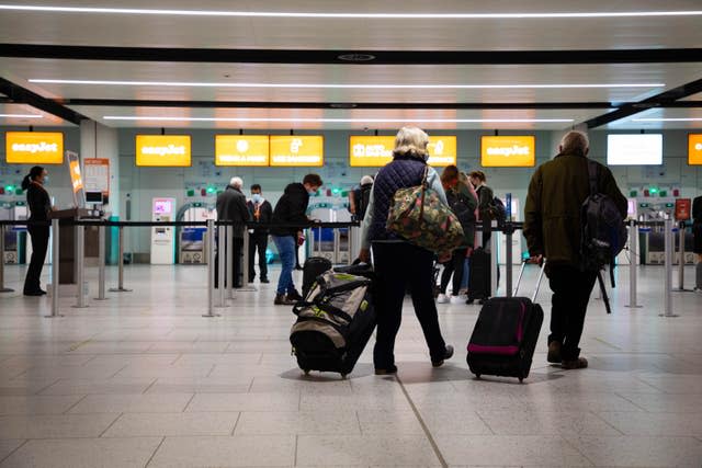 Passengers check in for the first holiday and leisure flight to take-off at Gatwick Airport, as easyJet relaunches flights from the UK to green-list destinations (David Parry/PA)