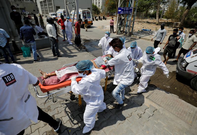 FILE PHOTO: A patient is wheeled inside a COVID-19 hospital for treatment, in Ahmedabad