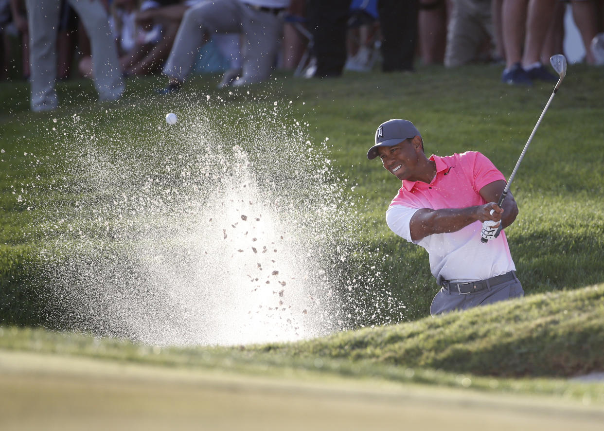 Tiger Woods hits out of a bunker on the 18th hole during the second round of the Honda Classic golf tournament, Friday, Feb. 23, 2018, in Palm Beach Gardens, Fla. (AP Photo/Wilfredo Lee)