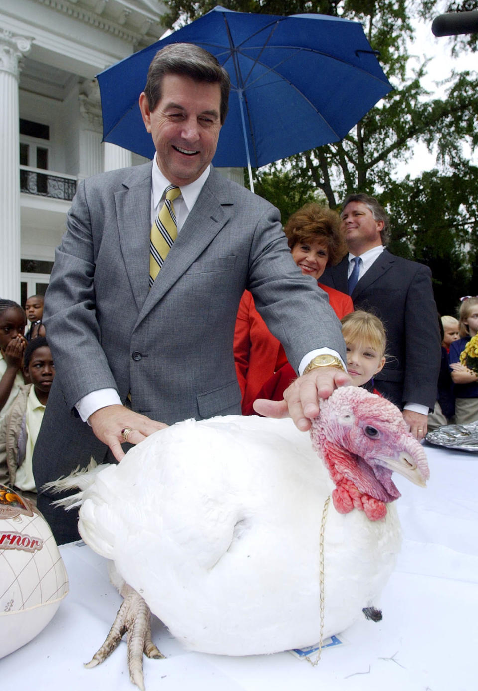 Alabama Gov. Bob Riley gives Clyde the Turkey a pat on the head Wednesday, Nov. 19, 2003, after issuing him a pardon during the annual turkey presentation to the governor by the Alabama Egg and Poultry Association. Turkey producer Bill Bates presented Riley with the turkey at the governor’s mansion in Montgomery, Ala.