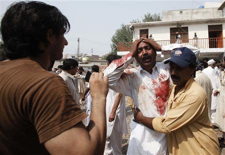 A man cries at the death of his brother at the site of a suicide blast at a church in Peshawar, September 22, 2013. REUTERS/Fayaz Aziz