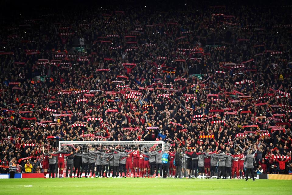 The Liverpool players and staff celebrate with fansa after the match (Getty Images)