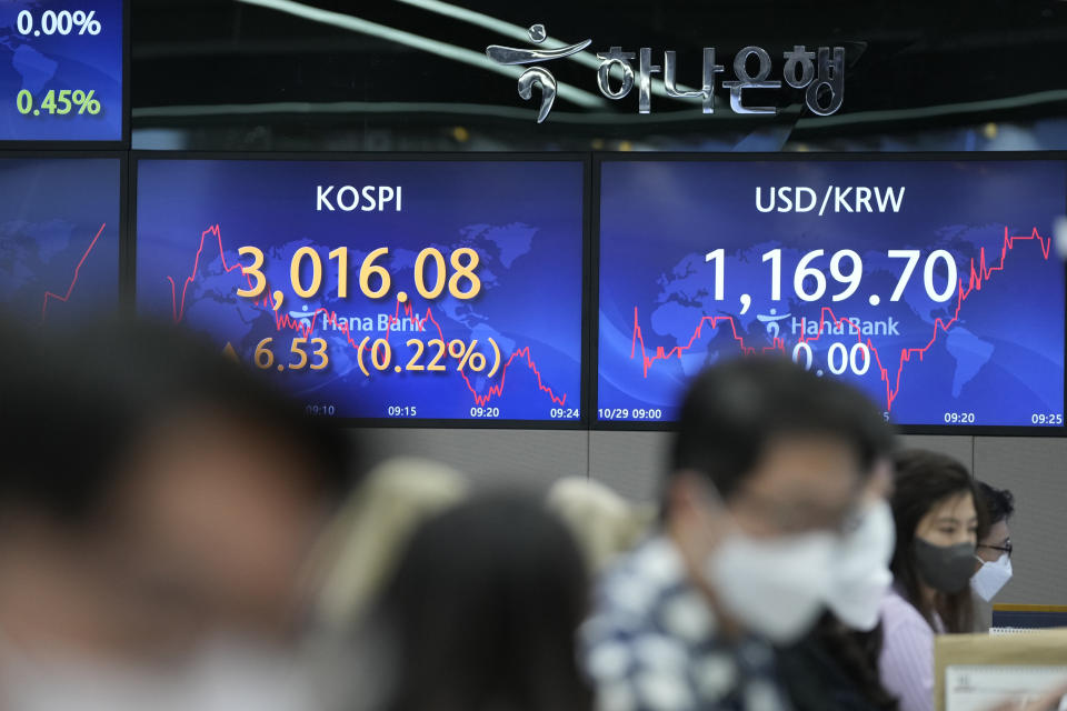 Currency traders work near the screens showing the Korea Composite Stock Price Index (KOSPI), left, and the foreign exchange rate between U.S. dollar and South Korean won at a foreign exchange dealing room in Seoul, South Korea, Friday, Oct. 29, 2021. Asian shares slipped on Friday, despite recent signs of optimism about the global economy, including recent rallies on Wall Street.(AP Photo/Lee Jin-man)