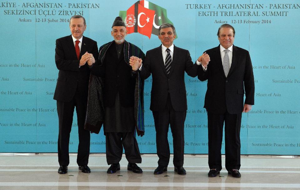 In this photo released by the Turkish Presidency Press Office, Turkish Abdullah Gul, second right, Turkish Prime Minister Recep Tayyip Erdogan, left, Afghan President Hamid Karzai, second left, and Pakistan Prime Minister Nawaz Sharif pose for cameras after their meeting in Ankara, Turkey, Thursday, Feb. 13, 2014. Karzai and Sharif are in Turkey for the 8th Afghanistan-Pakistan-Turkey Trilateral Summit.(AP Photo/Murat Cetinmuhurdar, Turkish Presidency Press Office, HO)