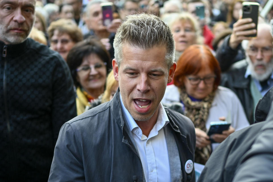 Peter Magyar, a former insider within Orban's ruling Fidesz party speaks during a protest outside the Hungarian Interior Ministry building to demand stronger protections for children and Interior minister Sandor Pinter to step down, in Budapest, Hungary, Friday, April 26, 2024. The demonstration was the latest in a series of large anti-government protests that Magyar has mobilized in recent weeks, and comes as the political newcomer is campaigning for EU elections this June with his new party, Respect and Freedom (TISZA). (AP Photo/Denes Erdos)