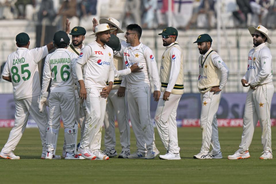 Pakistan's Abrar Ahmed, center, celebrates with teammates after taking wicket of England's Ben Stokes during the first day of the second test cricket match between Pakistan and England, in Multan, Pakistan, Friday, Dec. 9, 2022. (AP Photo/Anjum Naveed)