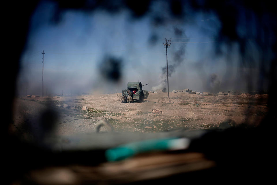 <p>Iraqi police fire from a Humvee at Islamic State positions from a hillside outside the town of Abu Saif, Feb. 20, 2017. Iraqi police have pushed into the southern outskirts of Mosul on the second day of a new push to drive Islamic State militants from the city’s western half. (AP Photo/Bram Janssen) </p>