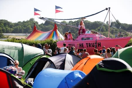 Protestors affiliated with Extinction Rebellion take part in a procession during Glastonbury Festival at Worthy farm in Somerset