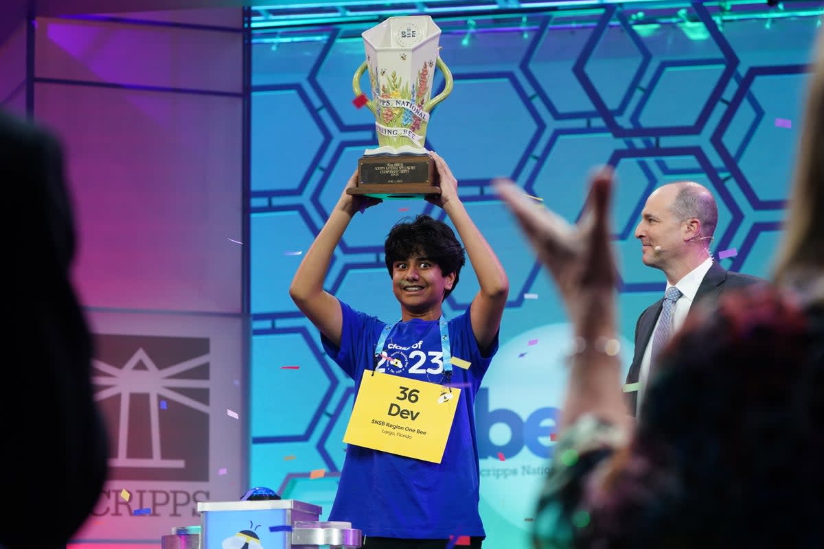 Dev Shah from Largo, Florida lifts the trophy after winning the final of the 95th Scripps National Spelling Bee (EPA)