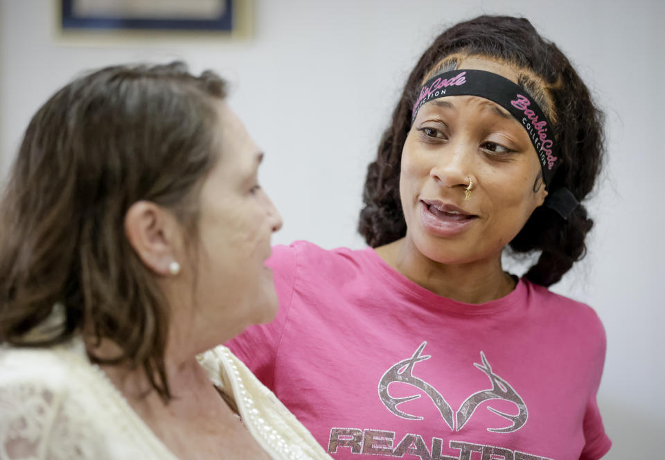 Arliya Martin, 26, right, talks to Kitty Sibley Morrison, principal and founder of Springfield Preparatory School, at school in Springfield, La., Thursday, July 27, 2023. Nearly 9,000 private schools in Louisiana don’t need state approval to grant degrees. Non-approved schools make up a small percentage of the state total. But the students in Louisiana’s off-the-grid school system are a rapidly growing example of the national fallout from COVID-19 — families disengaging from traditional education. (AP Photo/Scott Threlkeld)