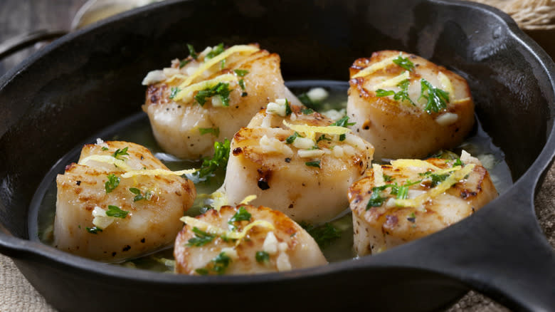 seasoned scallops cooking in a pan