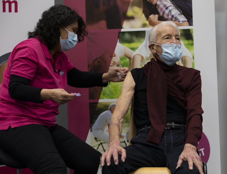 Jos Bieleveldt, 91, receives a COVID-19 vaccine in Apeldoorn, Netherlands, Tuesday, Jan. 26, 2021. Jos Bieleveldt had a spring in his 91-year-old step when he became one of the first Dutch recipients in his age group to get the coronavirus vaccine. One thing though, it really took too long a time coming. The 27-nation EU is coming under criticism for the slow rollout of its vaccination campaign. The bloc, a collection of many of the richest countries in the world, is not faring well in comparison to countries like Israel, the United Kingdom and the United States. (AP Photo/Peter Dejong)