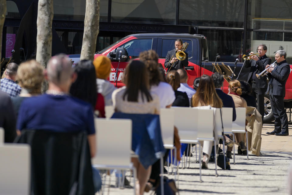 Members of the New York Philharmonic perform on the Lincoln Center campus as part of Restart Stages at Lincoln Center, Wednesday, April 7, 2021, in New York. Members of the New York Philharmonic gave an outdoor concert at Lincoln Center for heath care workers, 13 months after the novel coronavirus pandemic decimated their season. (AP Photo/Mary Altaffer)