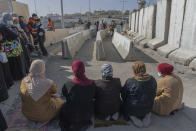 Palestinian women prepare to pray at the Qalandia checkpoint, to protest not allowing them to cross from the West Bank city of Ramallah toward Jerusalem, to attend the first Friday prayers in al-Aqsa mosque, during the Muslim holy month of Ramadan, Friday, April 16, 2021. A limited number of Palestinian residents who carry both a travel permit and a vaccination document, are allowed to cross into Israel to attend the prayers at al-Aqsa mosque, due to the coronavirus pandemic. (AP Photo/Nasser Nasser)