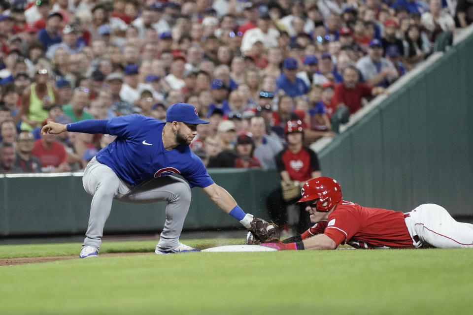 Cincinnati Reds' Harrison Bader, right, slides safely into third base on a steal as Chicago Cubs third baseman Nick Madrigal, left, attempts the tag during the ninth inning of a baseball game Saturday, Sept. 2, 2023, in Cincinnati. (AP Photo/Joshua A. Bickel)