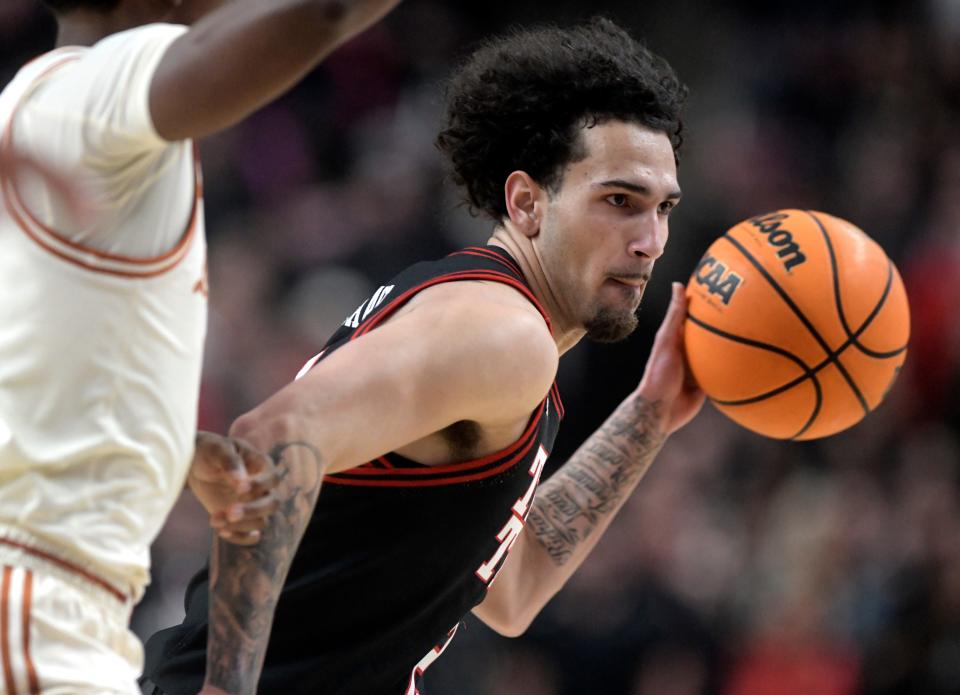 Texas Tech's guard Pop Isaacs (2) dribbles the ball against Texas in a Big 12 basketball game, Tuesday, Feb. 27, 2024, at United Supermarkets Arena.