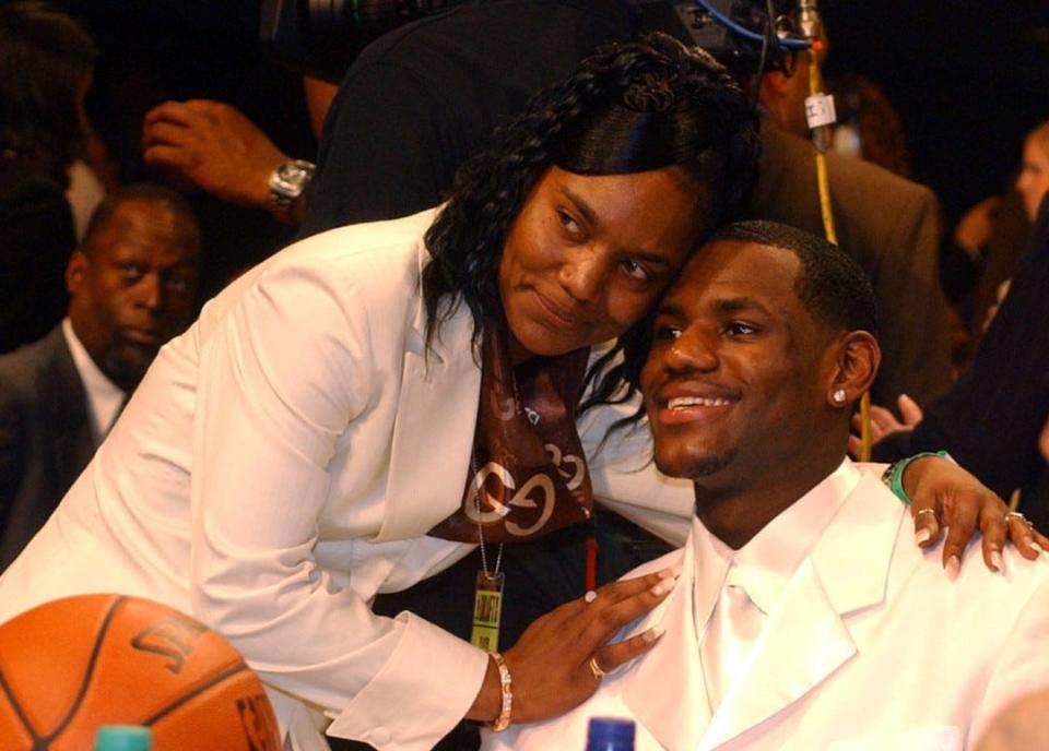 LeBron James gets a hug from his mother, Gloria James, moments after he was selected as the Cleveland Caviliers' first pick in the 2003 NBA Draft on June 26, 2003.