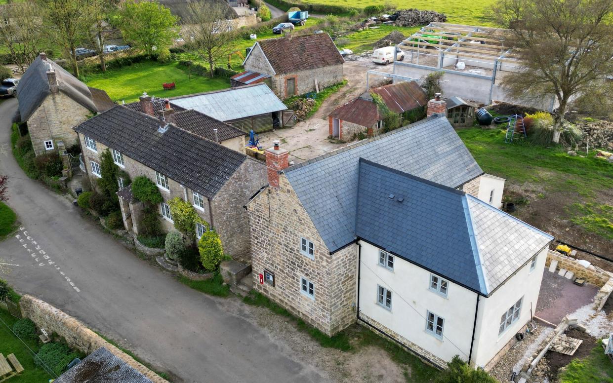 The couple's 17th century cottage (bottom right) in west Dorset