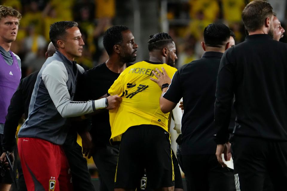 Jul 8, 2023; Columbus, Ohio, USA;  Columbus Crew defender Steven Moreira (31) and goalkeeper Evan Bush (24) hold back Wilfried Nancy during the second half of the MLS soccer match at Lower.com Field. Nancy was given a red card for his outburst resulting from a non-foul call. The Crew tied 1-1.