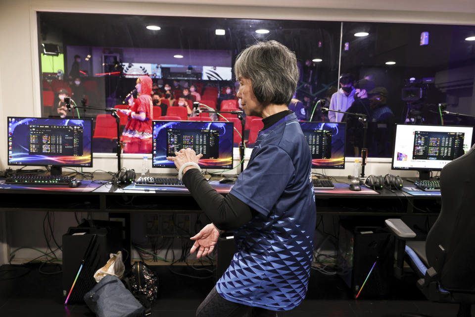 Sixty five-year-old Chiang Yi-Shu practices Taichi during the break from the game at Hungkuang University in Taichung, Taiwan on Saturday, Dec. 17, 2022. Chiang is one of the League of Legends players on Hungkung Evergreen Gaming's team, established this summer. The team, whose members range from 62 to 69 years old, was founded by Huang Jianji, the director of the department of Multimedia Game development and application of Hungkuang University. They competed in their first-ever video game tournament Saturday at the university. (AP Photo/I-Hwa Cheng)