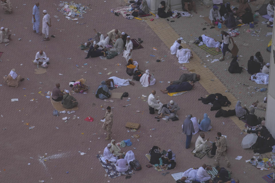 Muslim pilgrims rest after casting stones at pillars in the symbolic stoning of the devil, the last rite of the annual hajj, in Mina, near the holy city of Mecca, Saudi Arabia, Tuesday, June 18, 2024. Muslim pilgrims were wrapping up the Hajj pilgrimage in the deadly summer heat on Tuesday with the third day of the symbolic stoning of the devil, and the farewell circling around Kaaba in Mecca's Grand Mosque. (AP Photo/Rafiq Maqbool)