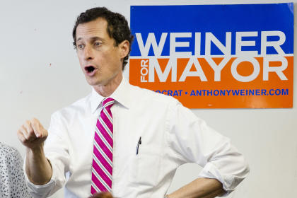 In this July 29, 2013, photo New York City mayoral candidate Anthony Weiner talks to voters in the Queens borough of New York. Weiner's campaign manager resigned after revelations emerged that Weiner continued to exchange sexually explicit online messages with women after he resigned from Congress in 2011 because of a sexting scandal. And in New York longtime Hillary Clinton aide Huma Abedin's decision to stick by Weiner, her husband, has drawn comparisons by Republicans to Clinton's support of her husband during reports of his infidelities, his impeachment by the House and subsequent acquittal by the Senate over his relationship with Monica Lewinsky. (AP Photo/John Minchillo, File)