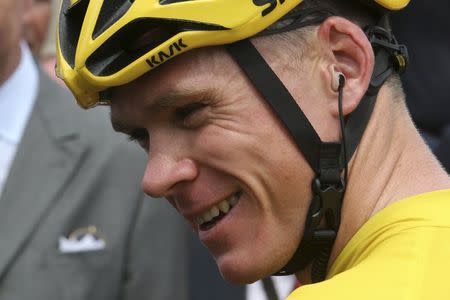 Race leader and yellow jersey holder, Team Sky rider Chris Froome of Britain, reacts before the 223.5-km (138.9 miles) 4th stage of the 102nd Tour de France cycling race from Seraing in Belgium, to Cambrai, France, July 7, 2015. REUTERS/Stefano Rellandini