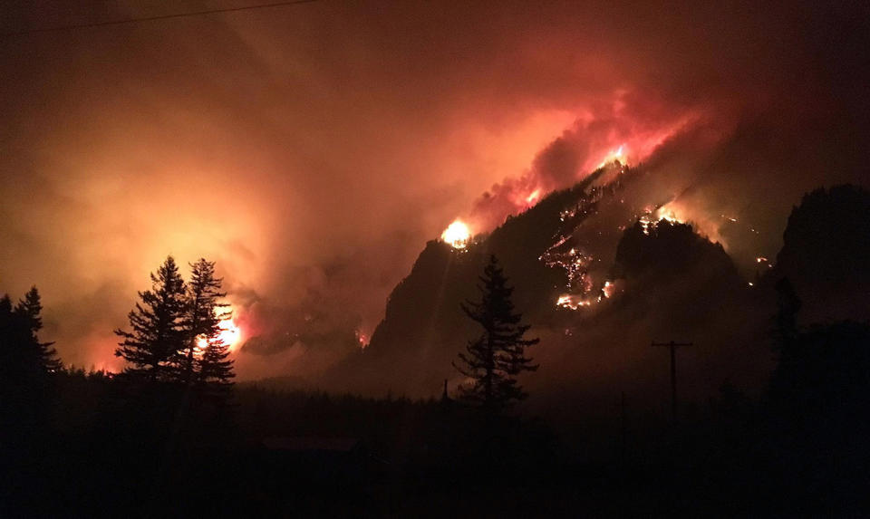 <p>This Sept. 4, 2017, photo provided by Inciweb shows a wildfire burning in the Columbia River Gorge east of Portland, Ore. A lengthy stretch of highway Interstate 84 remains closed Tuesday, Sept. 5, as crews battle the growing wildfire that has also caused evacuations and sparked blazes across the Columbia River in Washington state. (Photo: Inciweb via AP) </p>