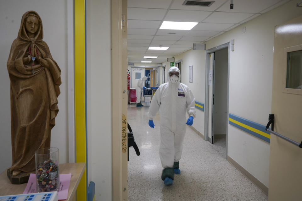 A medical staffer makes his way to the ICU unit of Rome's San Filippo Neri Hospital's Covid department, Thursday, April 9, 2020. The new coronavirus causes mild or moderate symptoms for most people, but for some, especially older adults and people with existing health problems, it can cause more severe illness or death. (AP Photo/Andrew Medichini)