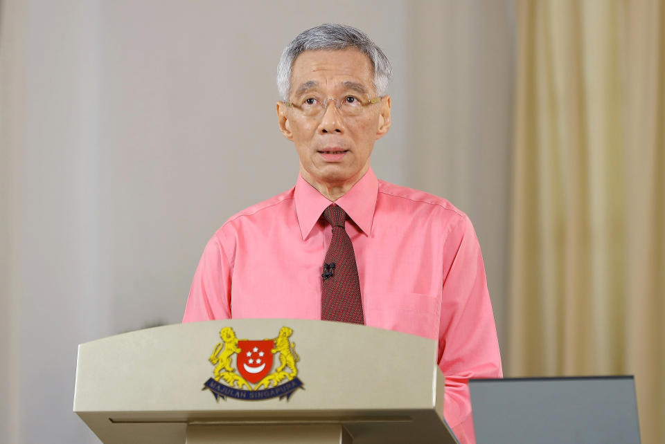 In this photo provided by Singapore Ministry of Communications and Information on Tuesday, June 23, 2020, Singapore Prime Minister Lee Hsien Loong makes an announcement about general elections in Singapore. Lee called for early elections to seek a fresh mandate despite the coronavirus pandemic. (Singapore Ministry of Communications and Information via AP)