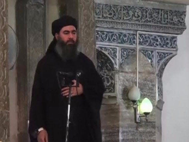  Abu Bakr al-Baghdadi  at a mosque in the centre of Iraq's second city, Mosul, according to a video recording posted on the Internet on July 5, 2014, in this still image taken from video.   REUTERS/Social Media Website via Reuters TV  