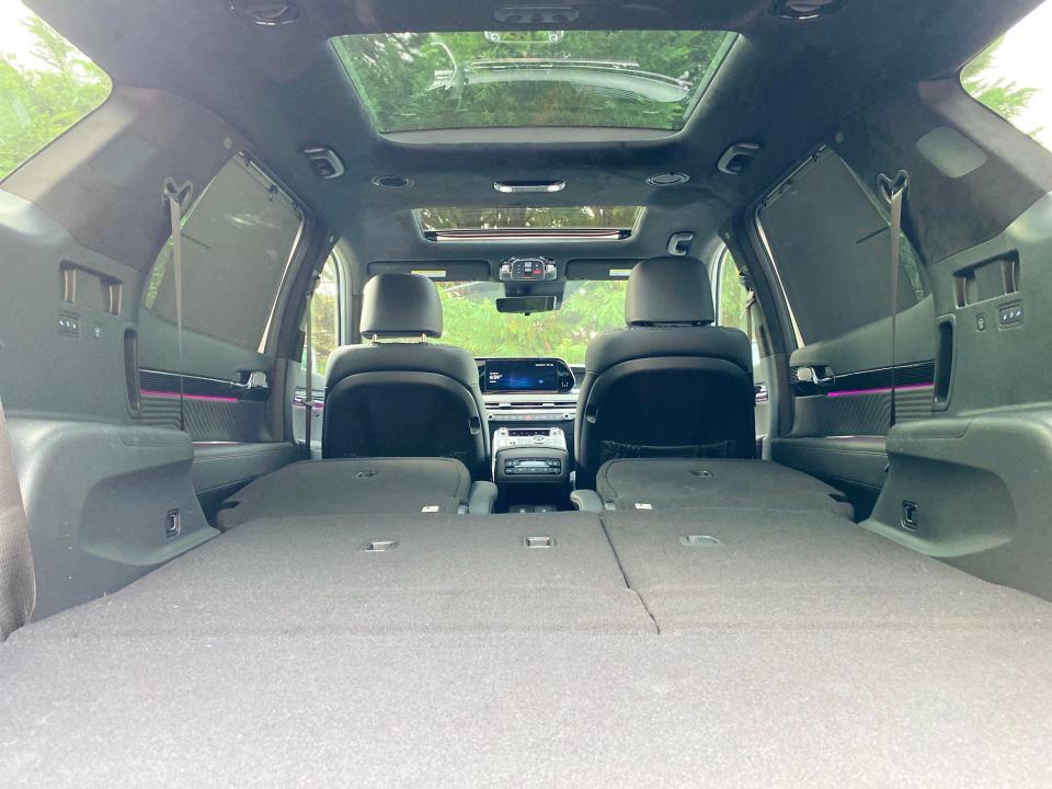 The interior of a 2024 Hyundai Palisade SUV with the second and third-row seats folded.