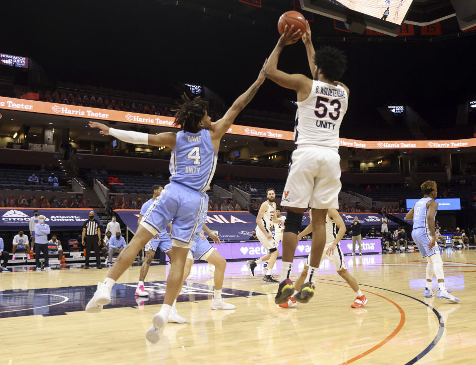 Virginia guard Tomas Woldetensae (53) shoots over North Carolina guard R.J. Davis (4) during an NCAA college basketball game Saturday, Feb. 13, 2021, in Charlottesville, Va. (Andrew Shurtleff/The Daily Progress via AP, Pool)