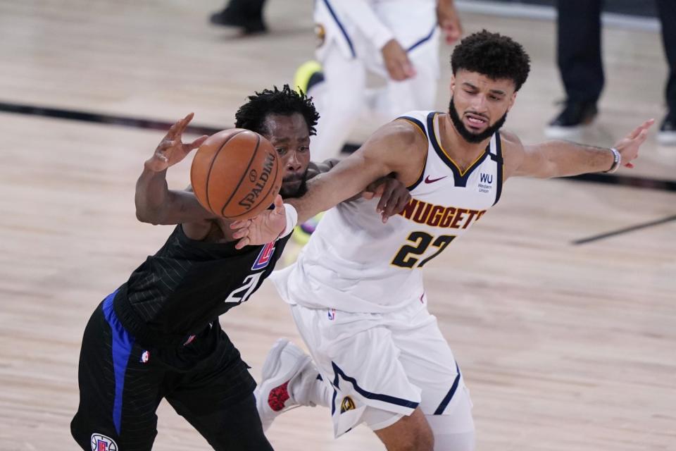 Clippers guard Patrick Beverley, left, is pressured by Denver's Jamal Murray.